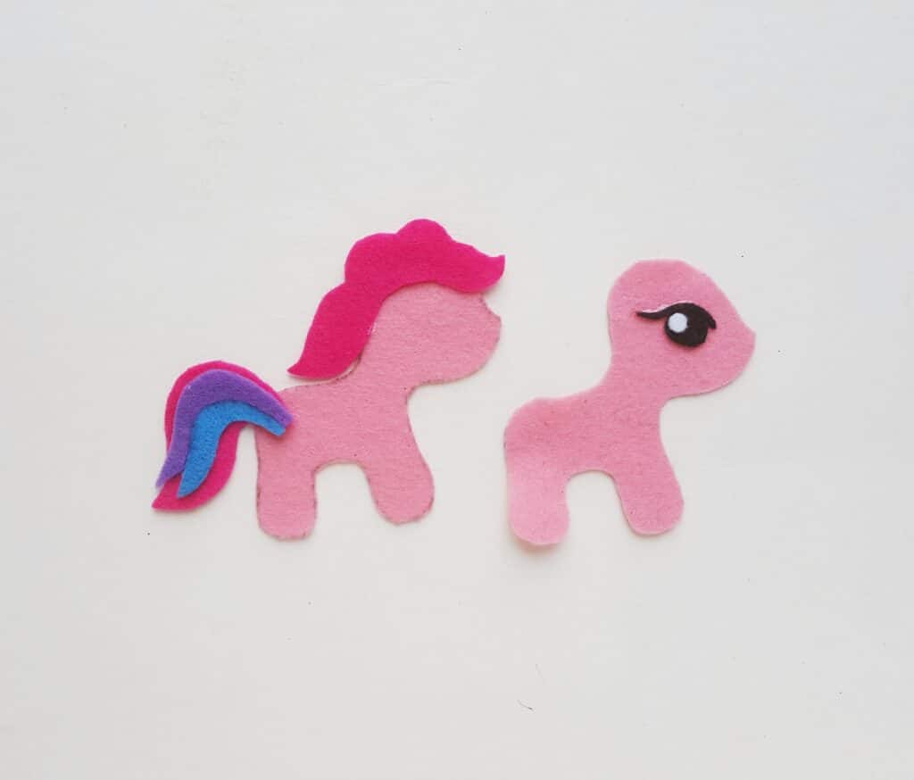 two pink felt pony cut outs with colorful tail glued on