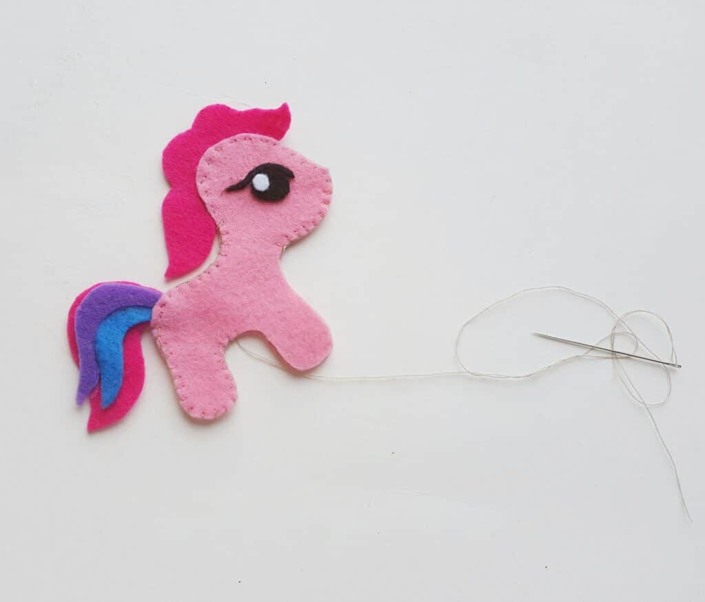 stitching seams of pink felt pony template