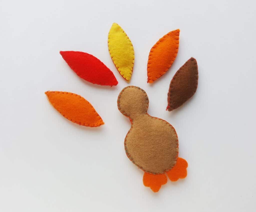 stuffed felt pieces of turkey template craft against white background