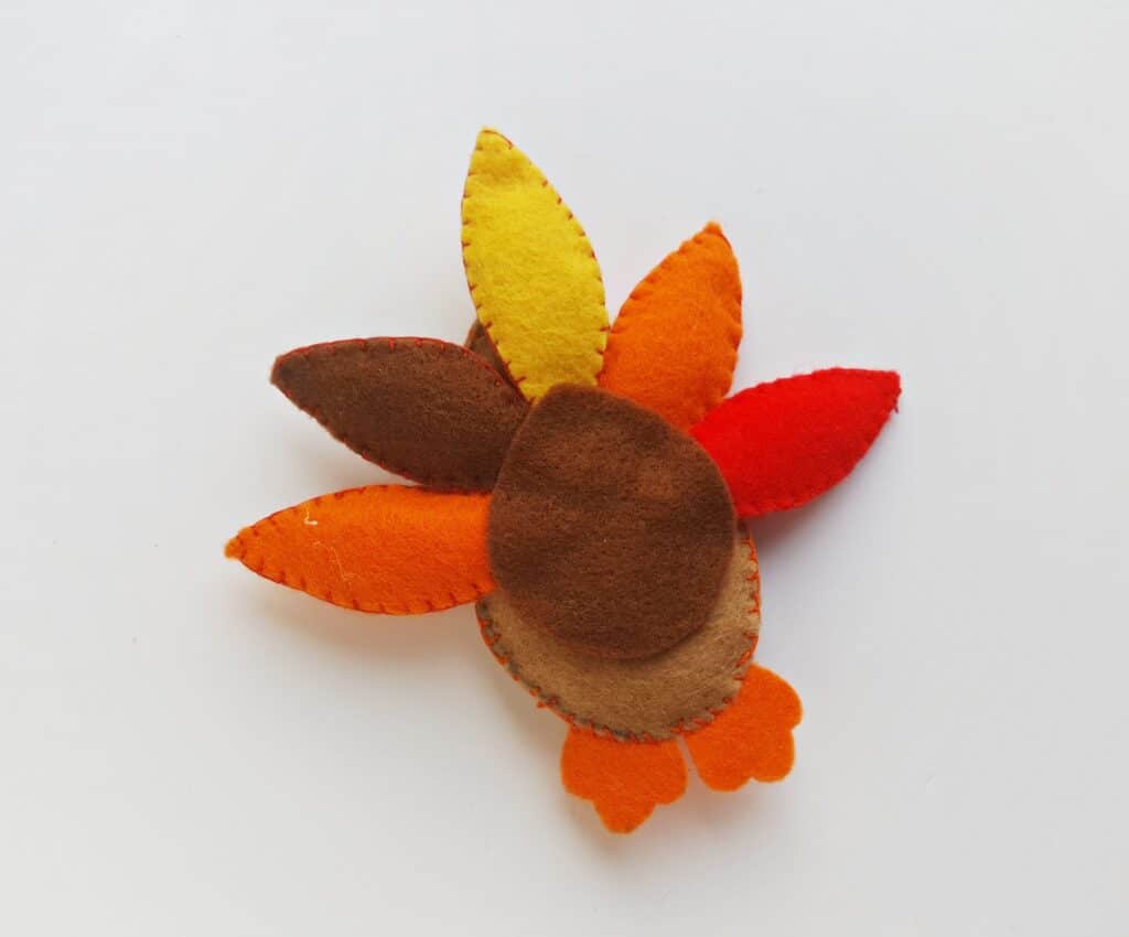 stuffed turkey felt craft with brown felt circle covering feathers