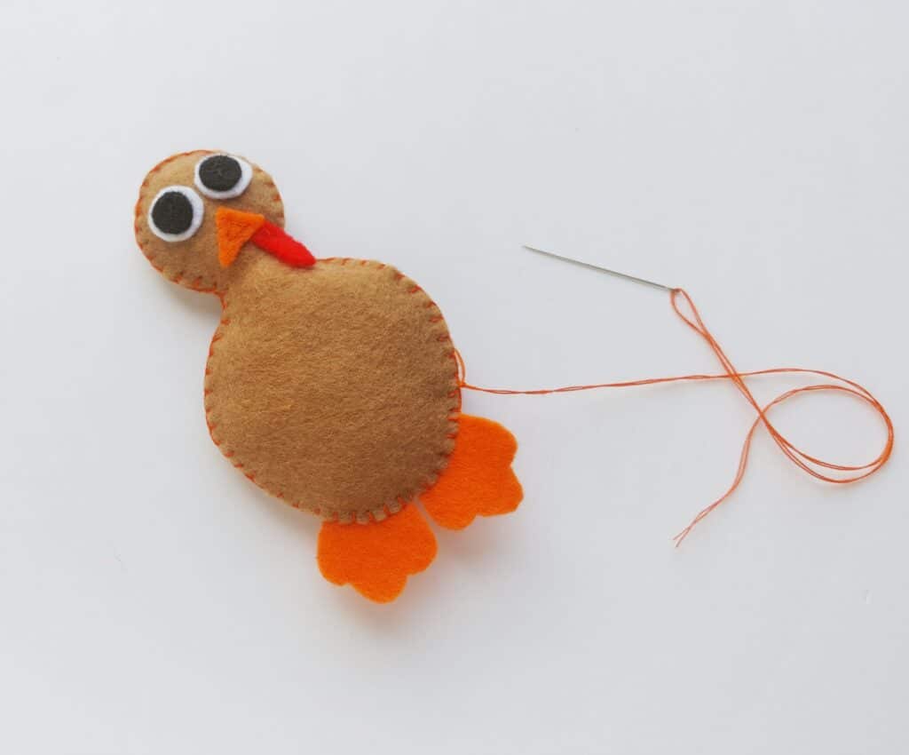 stitching felt turkey templates together with orange thread