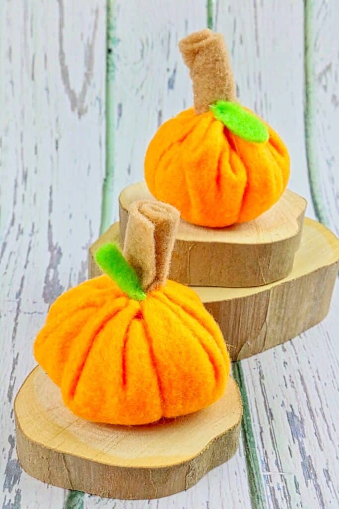 felt mini pumpkins on wood slices