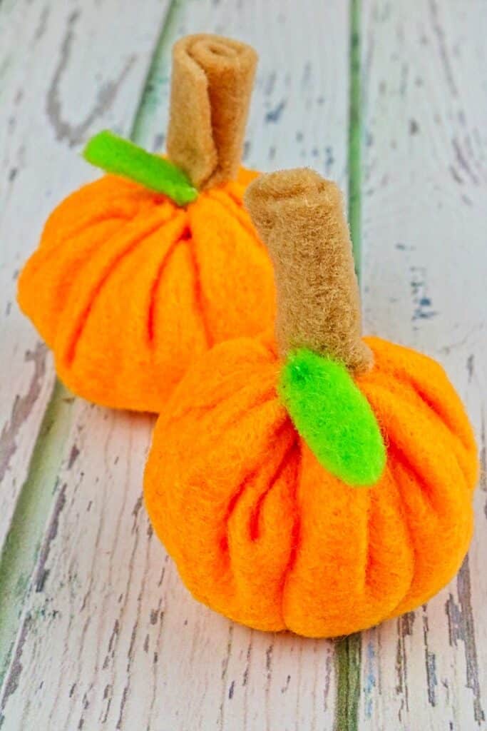 closeup image of mini felt pumpkins on table