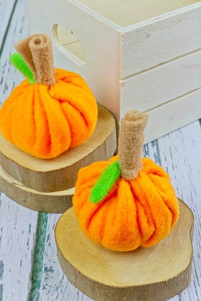 mini felt pumpkins on table
