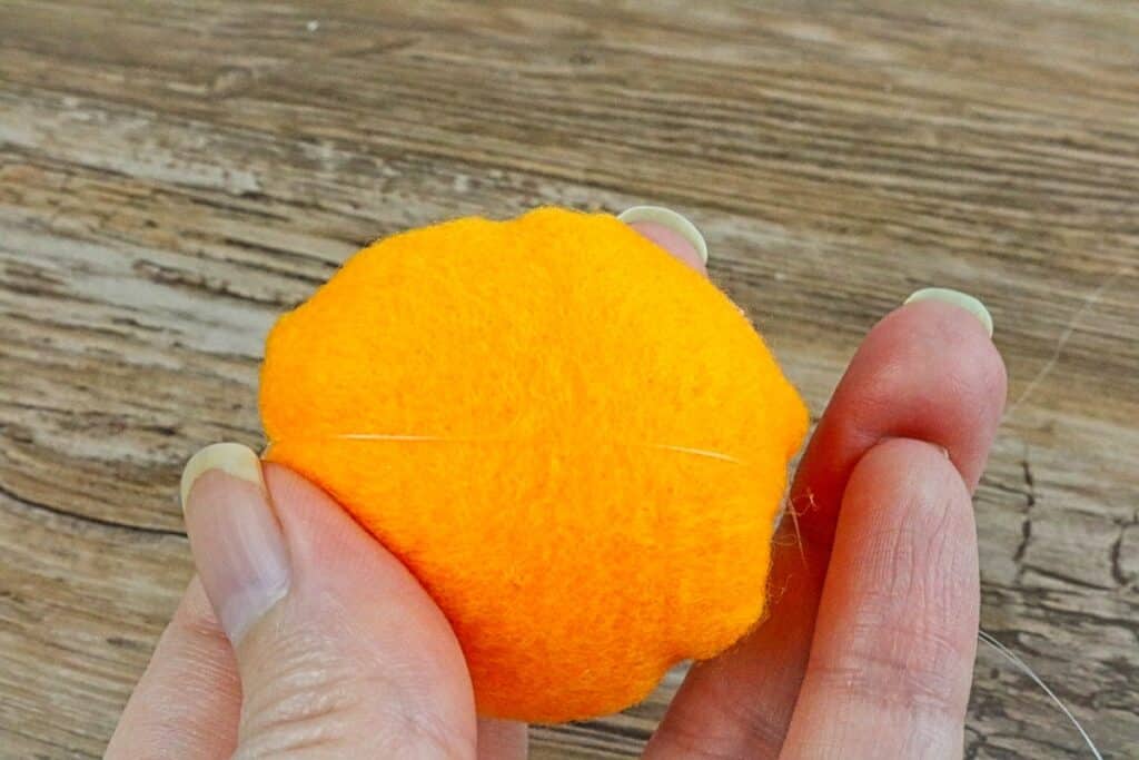 mini felt pumpkin rolled around cotton ball