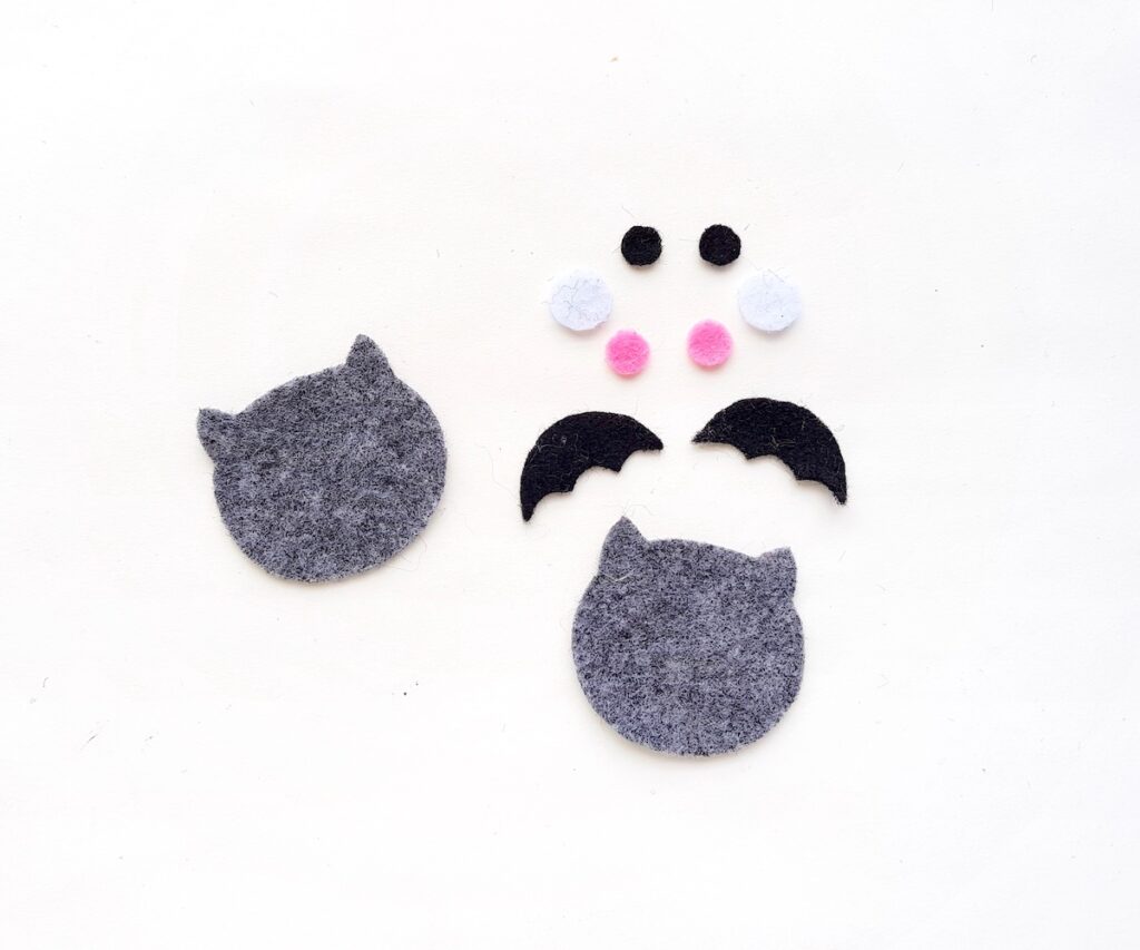 cutouts of a grey plush felt halloween bat toy