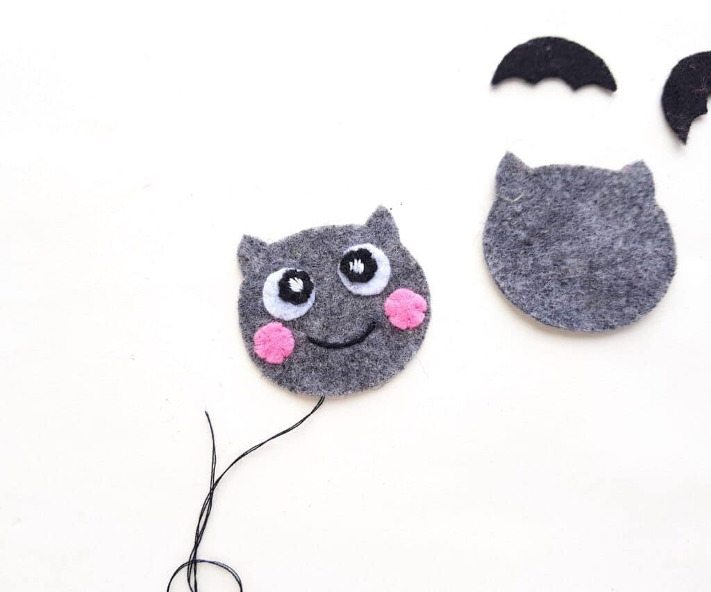 grey felt plush bat doll with facial features