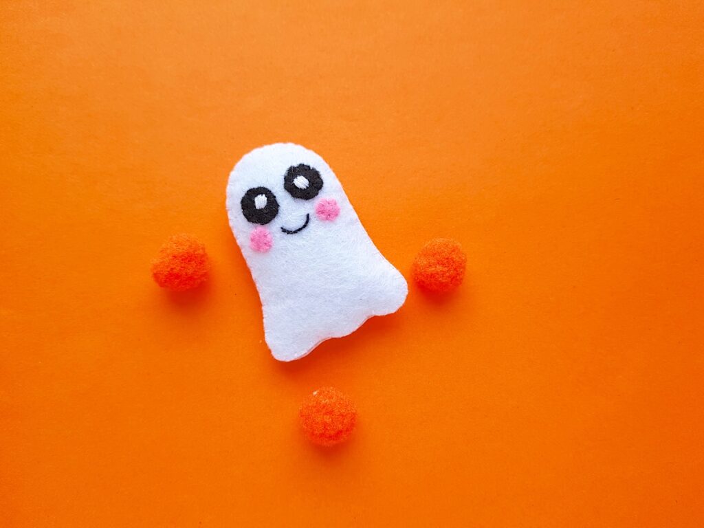 Cute Ghost felt plushie on orange background