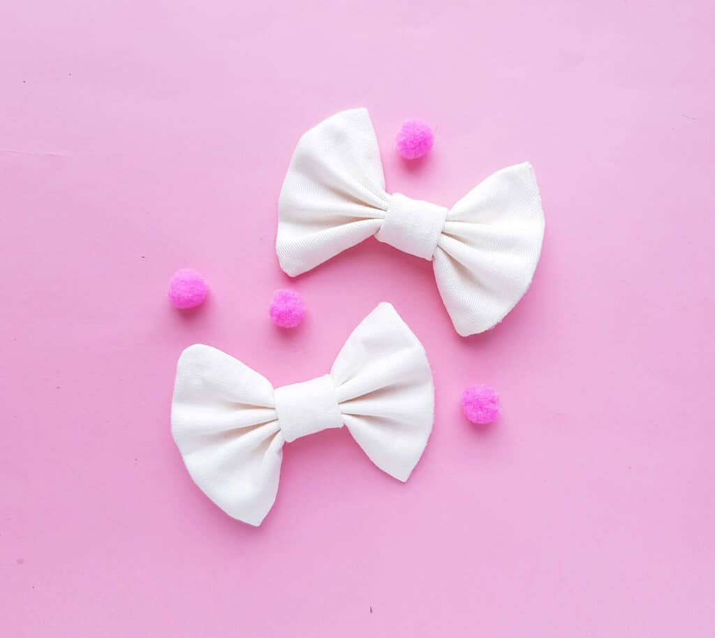 two white bows on pink background