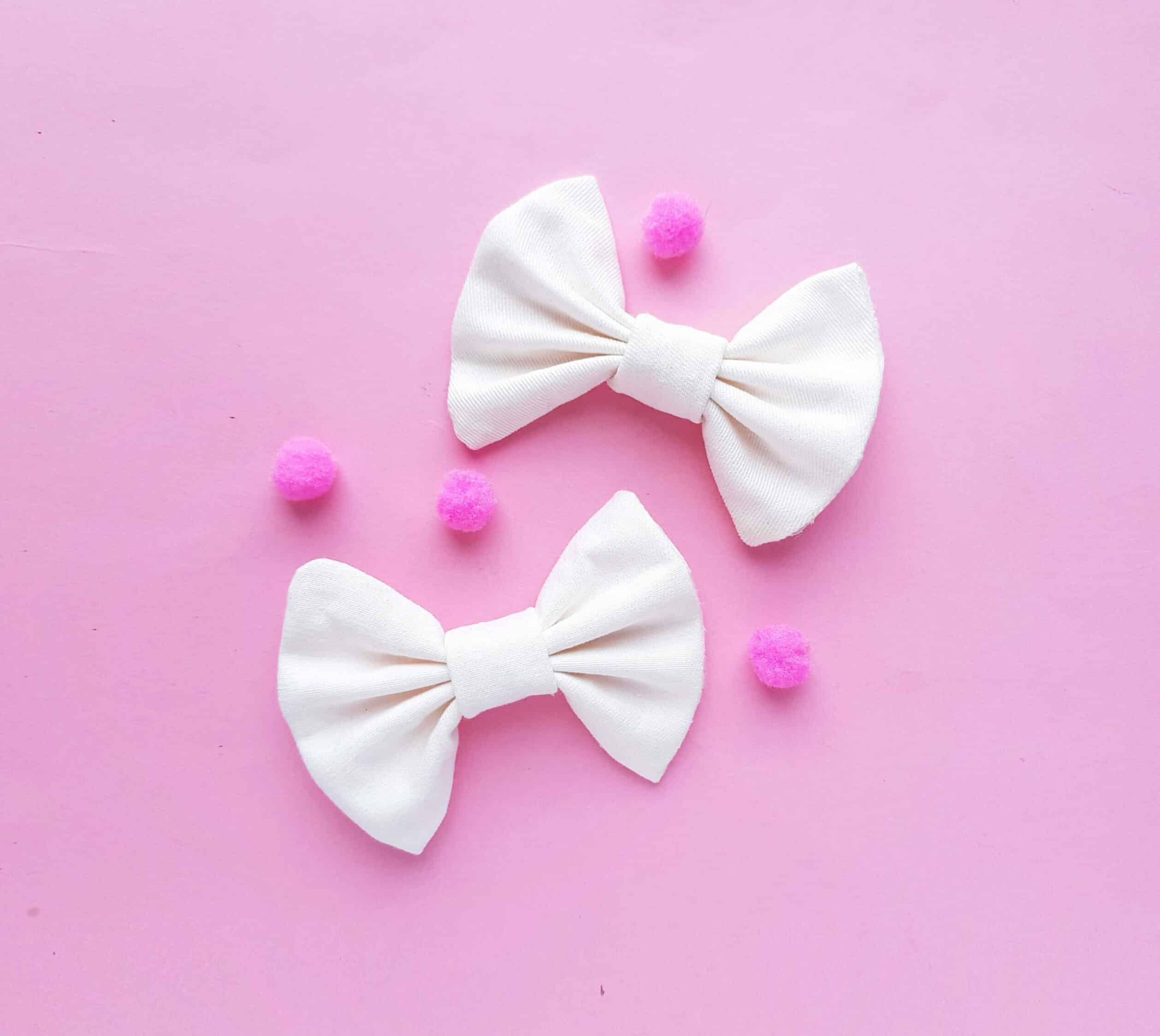 two white bows on pink background
