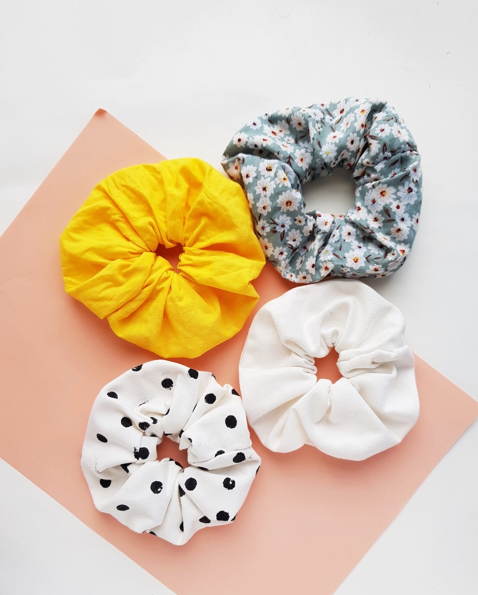 four hair scrunchies made from fabric