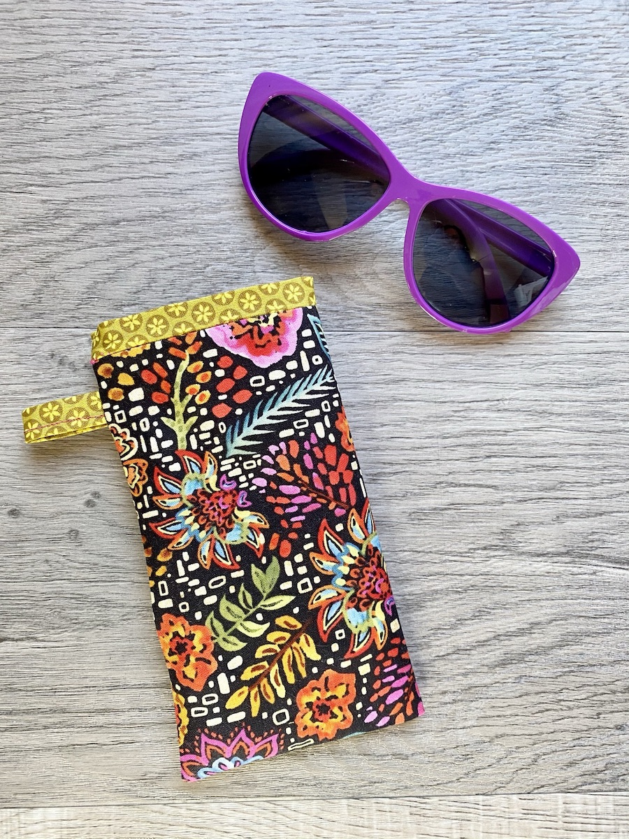 Sunglasses Case on table with pink sunglasses