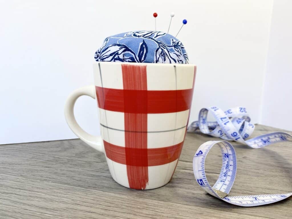teacup pin cushion in mug on desk