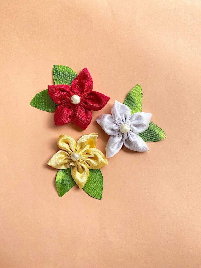 How To Sew Satin Flowers clustered on beige background