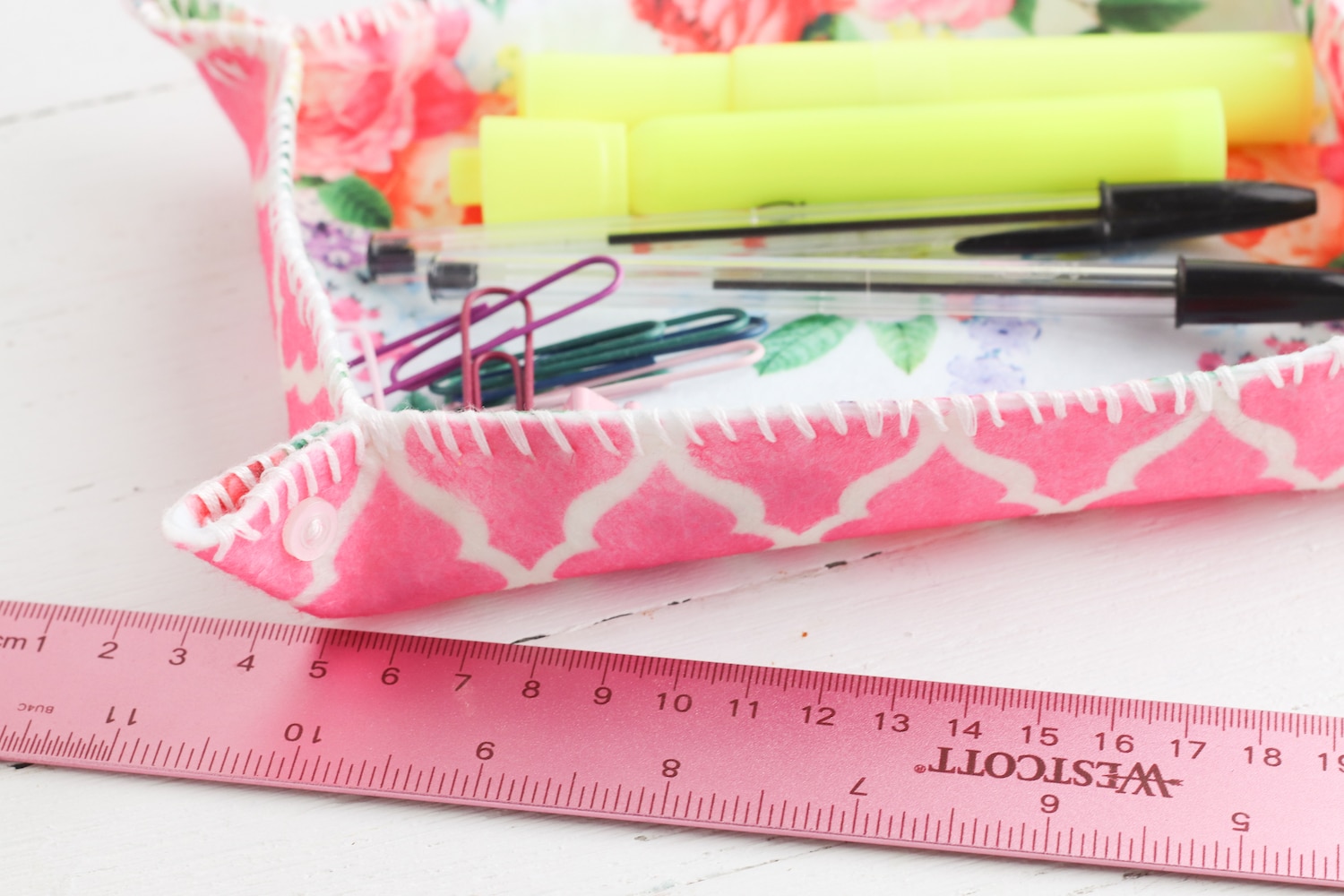 pink ruler next to felt fabric storage tray