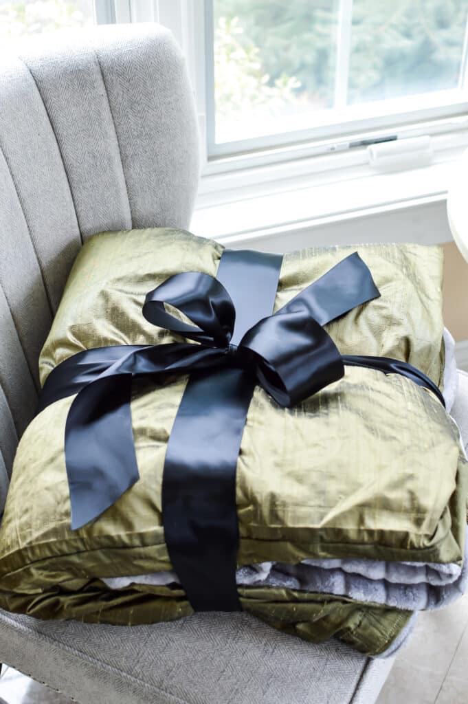 handmade double sided blanket folded and wrapped in black satin ribbon for a gift