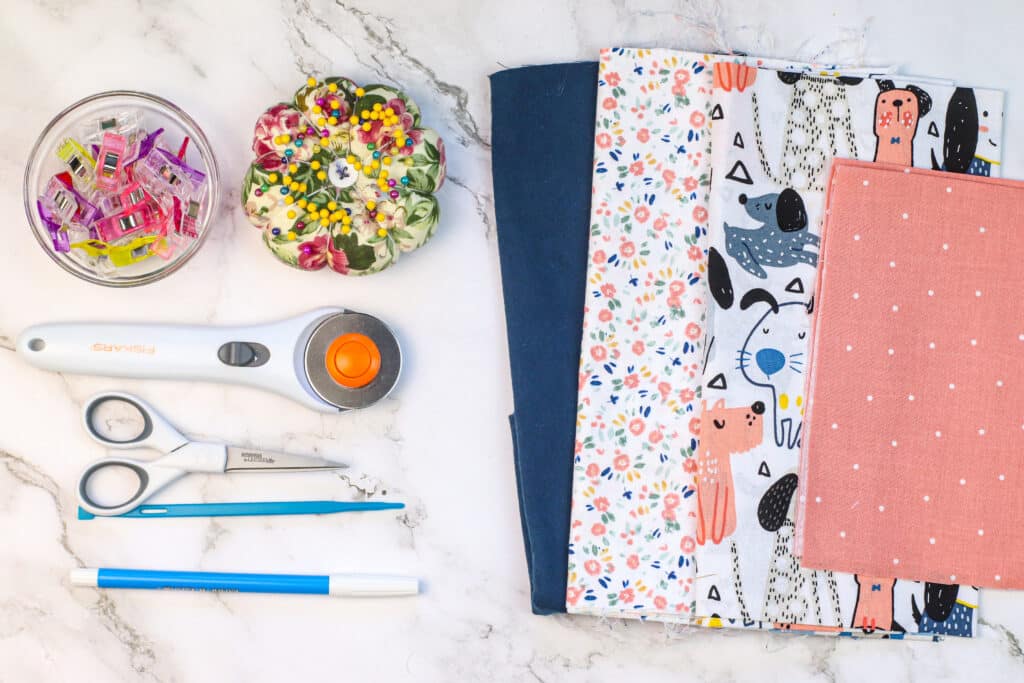 A table with scissors, fabric, and other craft supplies.