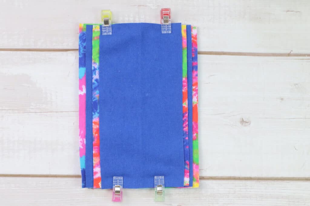 A blue and colorful cloth diaper on a wooden table.