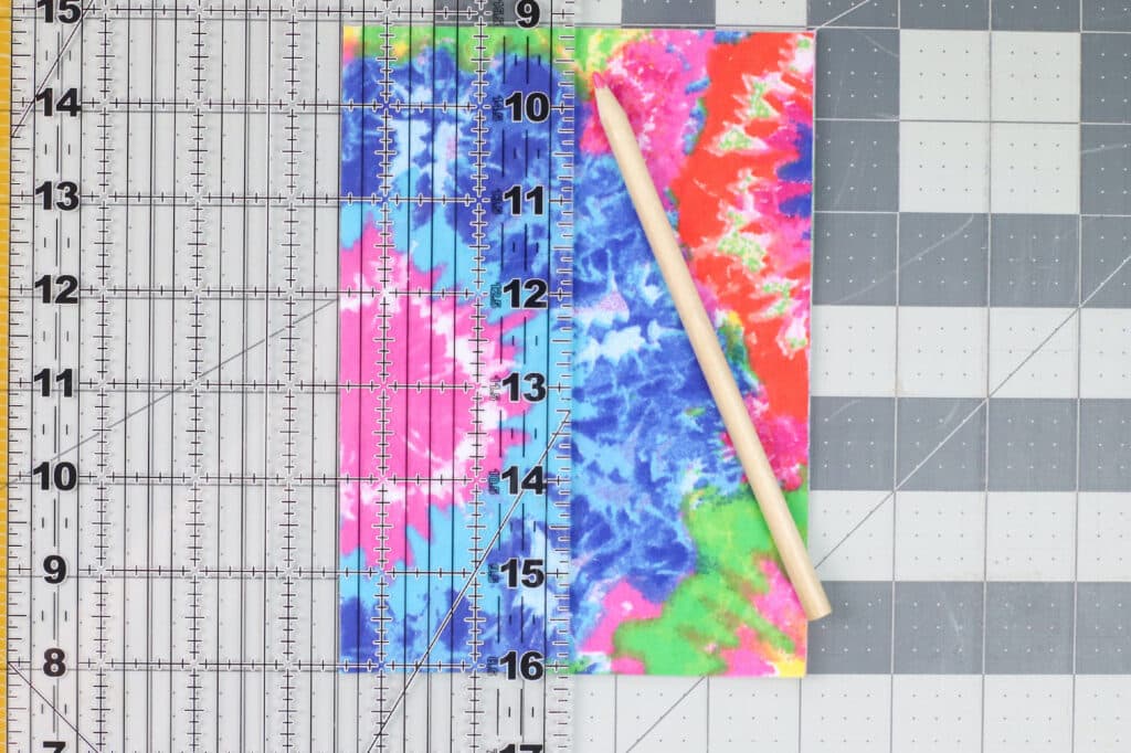 A ruler next to a ruler with a tie dye pattern on it.