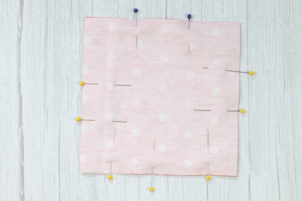 A pink polka dot fabric perfect for DIY dryer sheets.