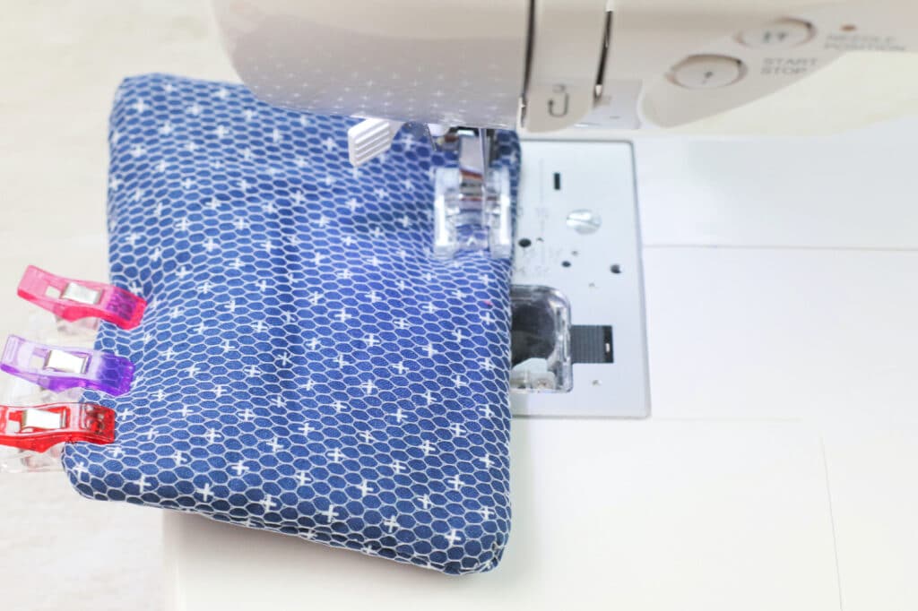 A sewing machine with a blue fabric on top.