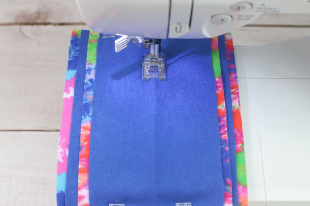 A sewing machine with a blue fabric on it.