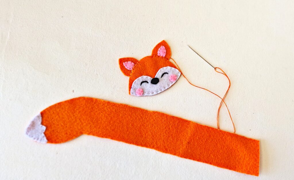 Step 7 A felt fox with a needle and thread.