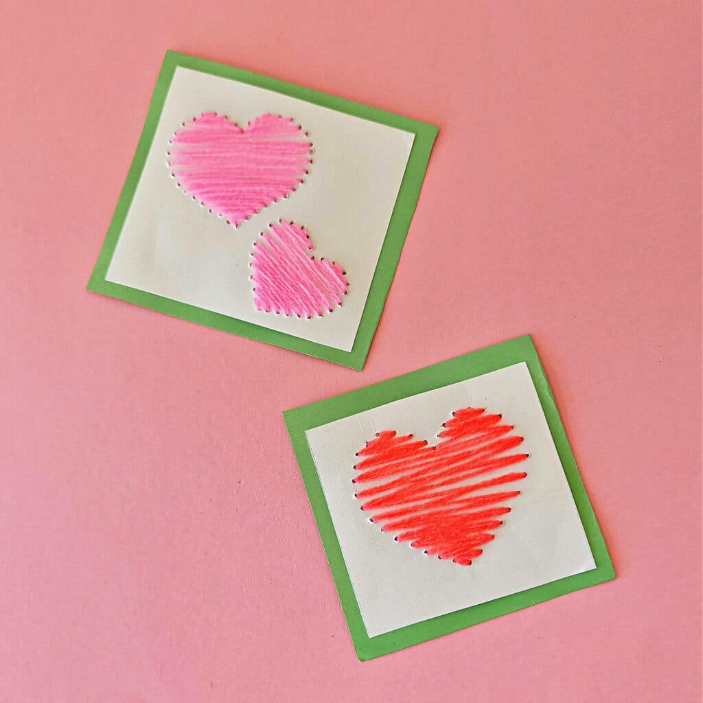 Two Valentine's Day cards adorned with pink and red hearts.