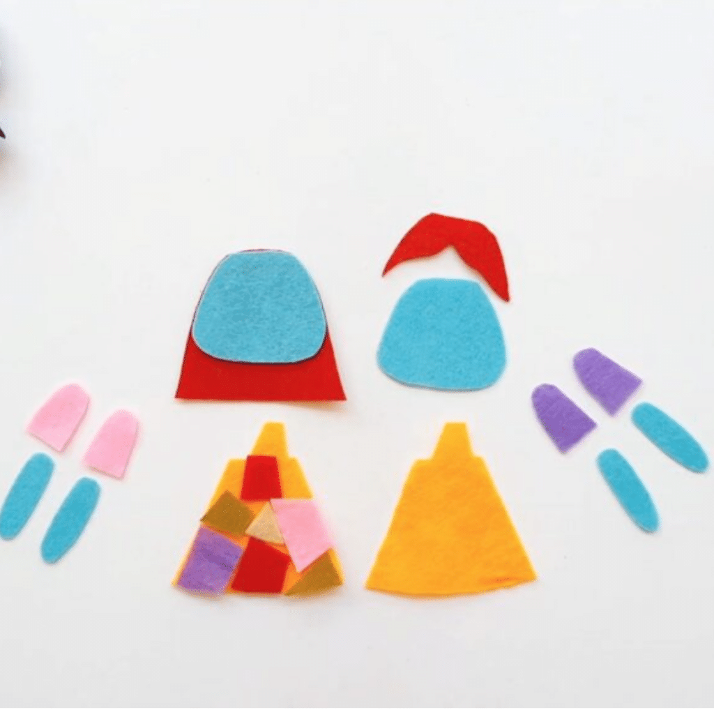 A set of felt pieces and scissors on a white surface.