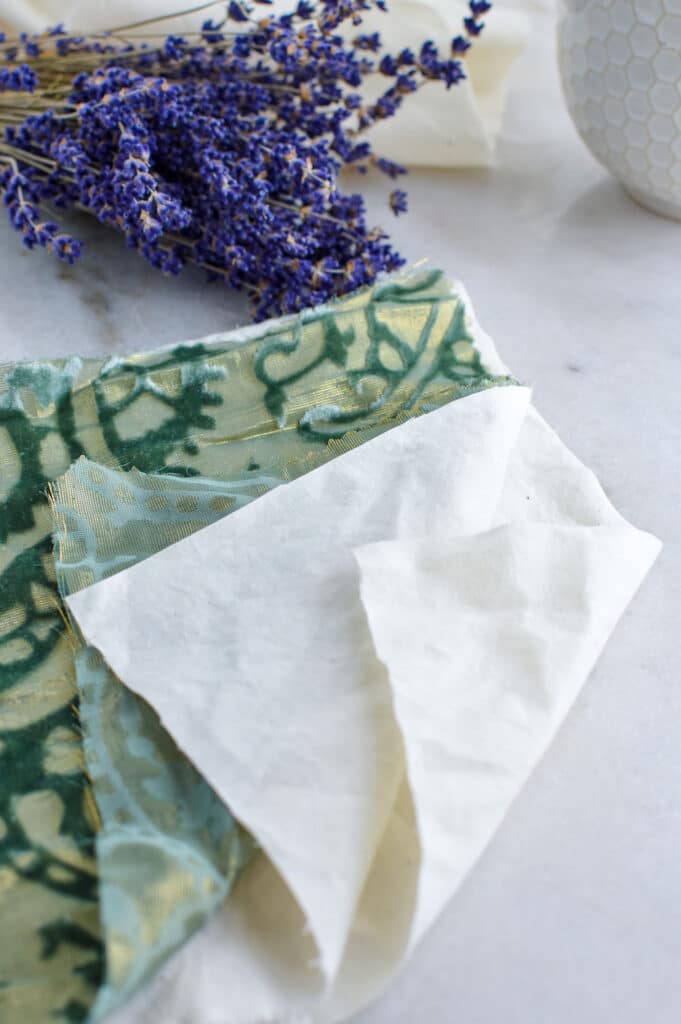 A DIY eye pillow made from a piece of paper with lavender flowers on it.