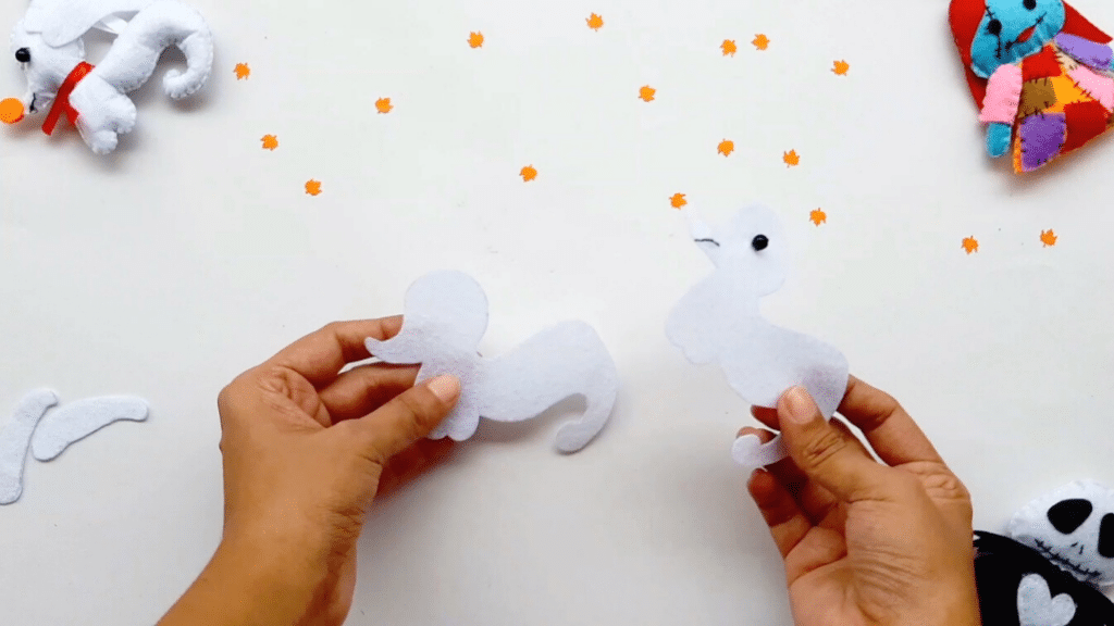 A person is making a stuffed animal out of felt.