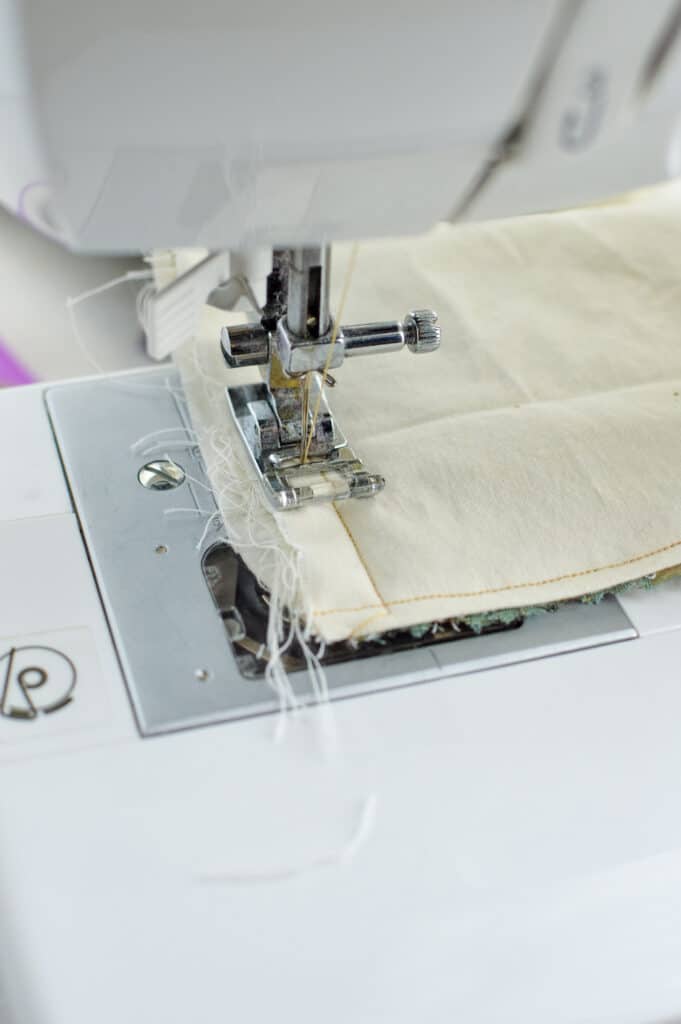 A sewing machine is being used to stitch together a diy eye pillow.