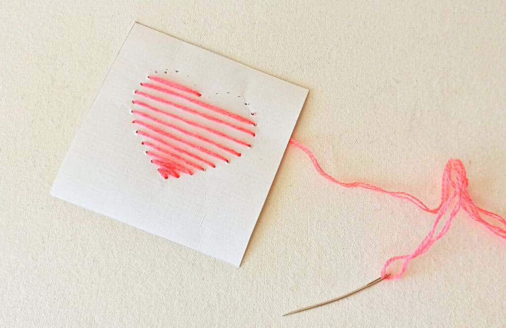 A piece of paper with a pink heart on it.