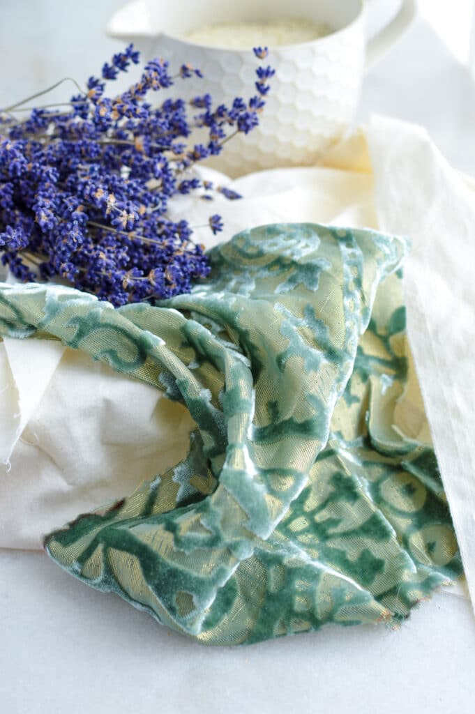A diy eye pillow made with a piece of fabric adorned with lavender flowers.