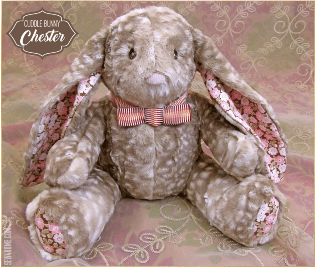 A stuffed bunny with a pink bow tie created using bunny sewing patterns.