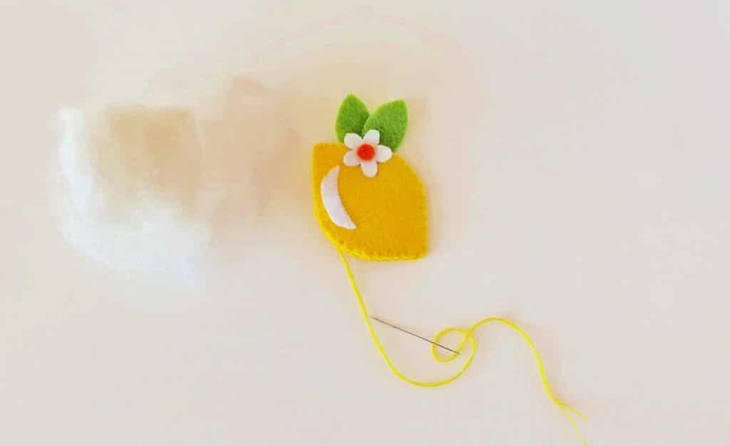 Felt Lemon Step 7 -A felt flower with a thread attached to it.