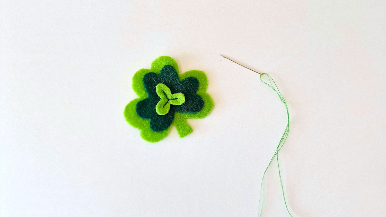 Felt Shamrock Bookmark Step 4 -A needle and a green felt clover.