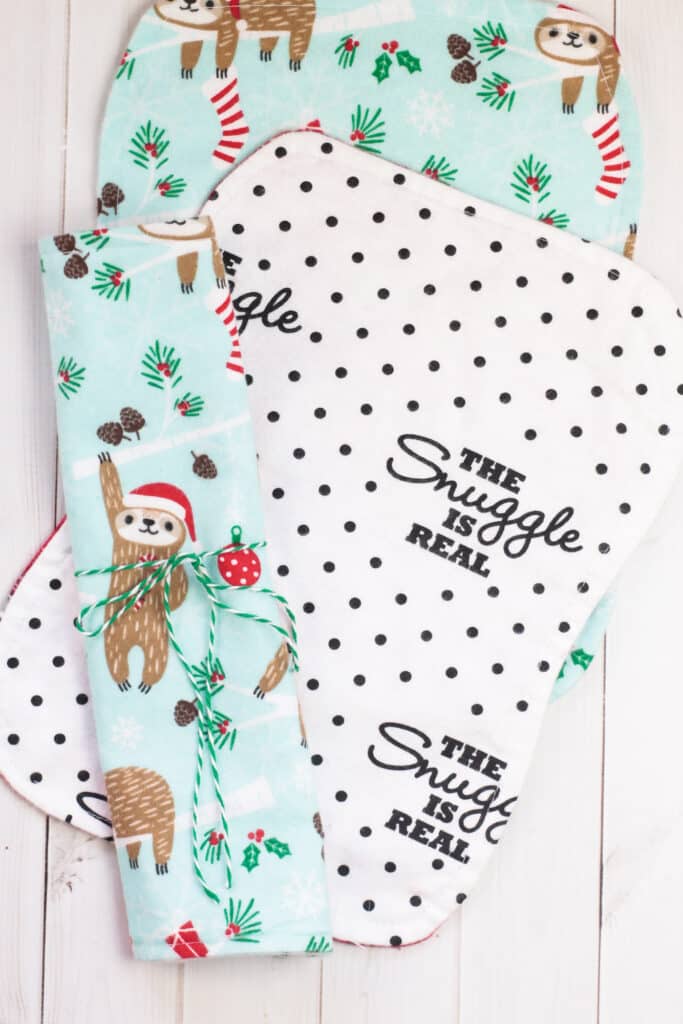 A set of baby wipes with a sloth and santa claus on them.