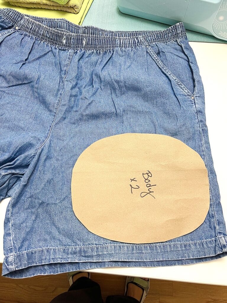 A pair of denim shorts with a turtle patch on them.
