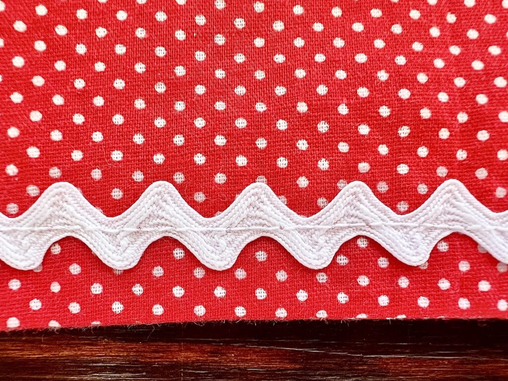 A red and white polka dot fabric on a table.