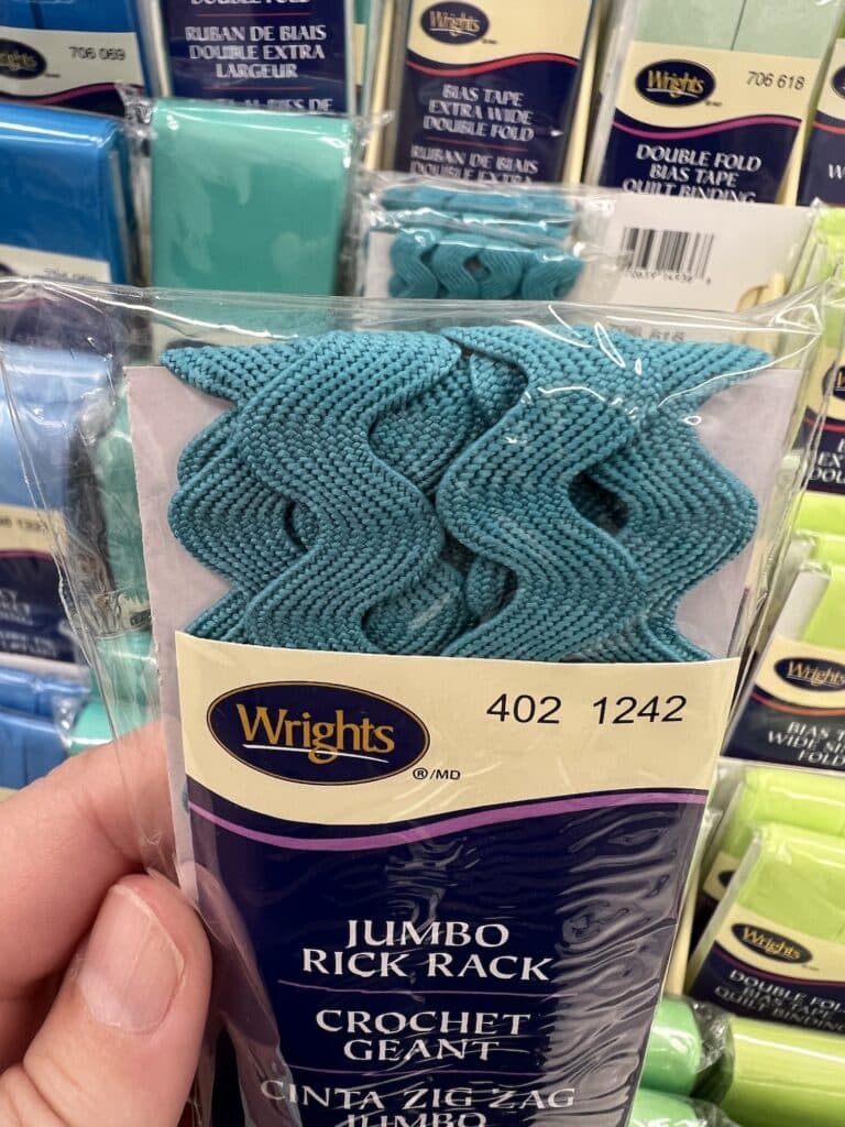 A package of wright's limbo crochet thread with rick rack accents in a store.