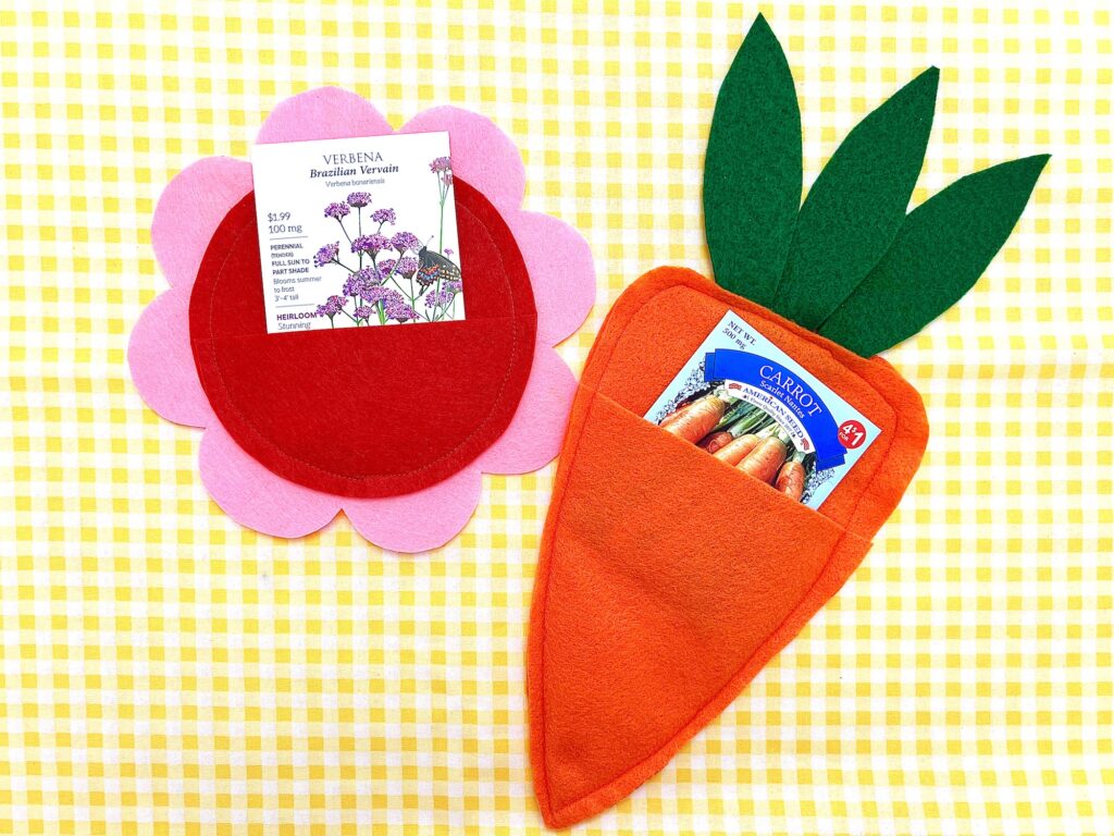 Colorful felt garden-themed seed packet display on a checkered background.