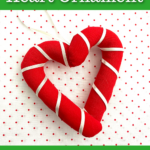 A heart-shaped ornament crafted from red and white fabric sits on a polka-dotted background. Text reads: "Candy Cane Heart Ornament" and "Free Pattern!" from EasyThingsToSew.com.