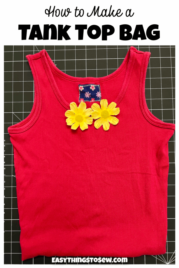 A red tank top folded flat with two yellow artificial flowers on the chest, featured in a t-shirt bag DIY tutorial.