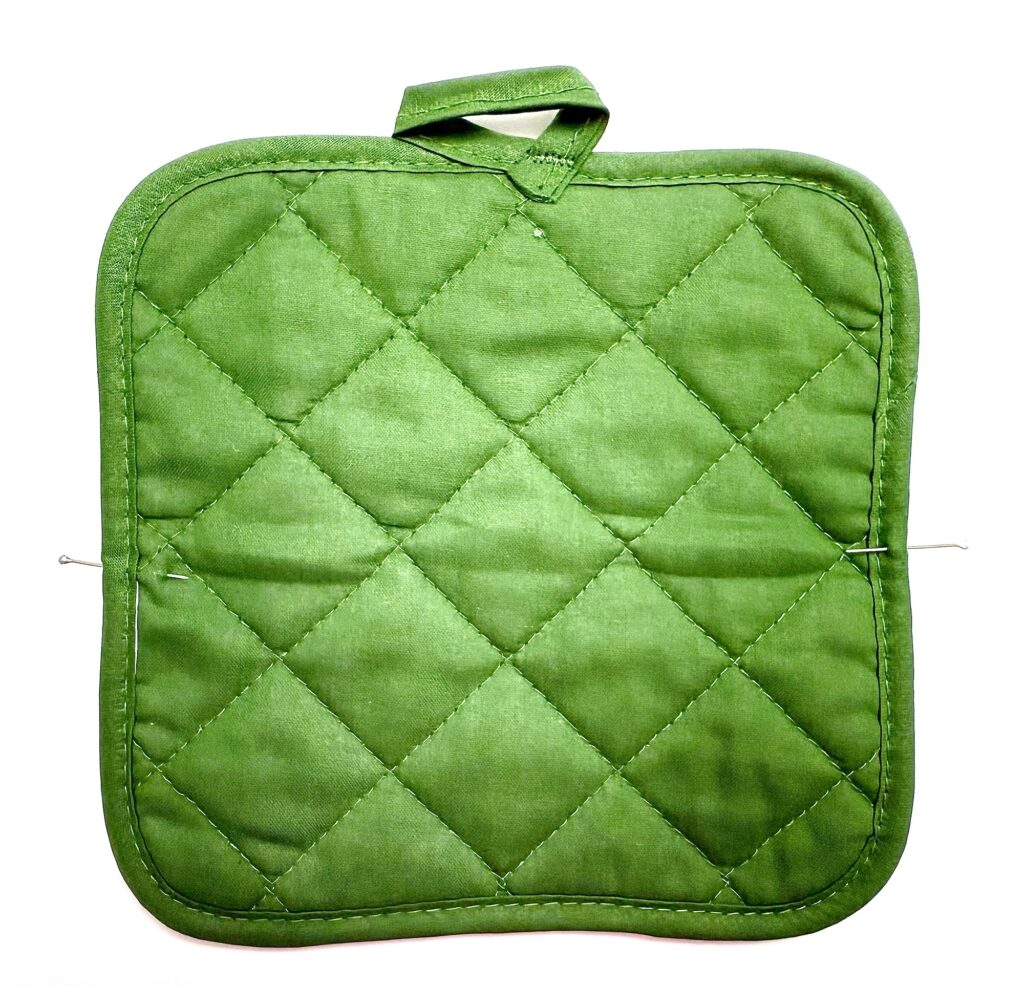 A green quilted fabric pot holder with a convenient hanging loop, shown against a white background.