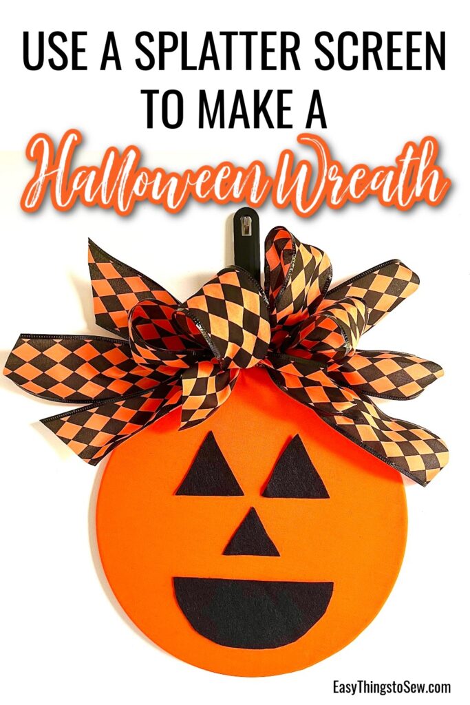 An orange splatter screen decorated with black felt pumpkin face features and a black-and-orange checkered bow is transformed into a festive Halloween wreath craft.