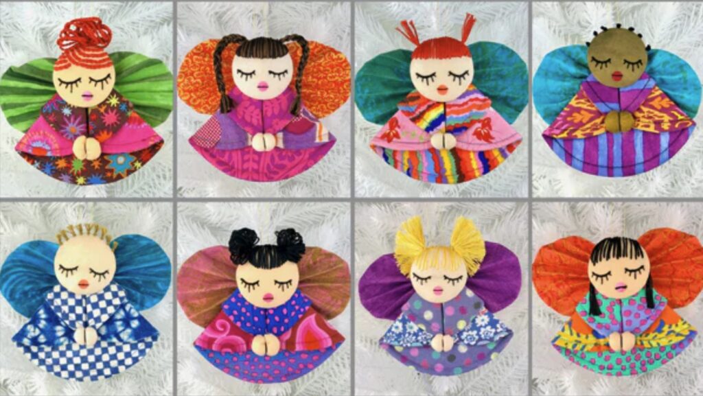 Eight handmade angel ornaments with colorful wings and dresses, each with closed eyes and varied hair colors and styles, arranged in a grid on a light background.
