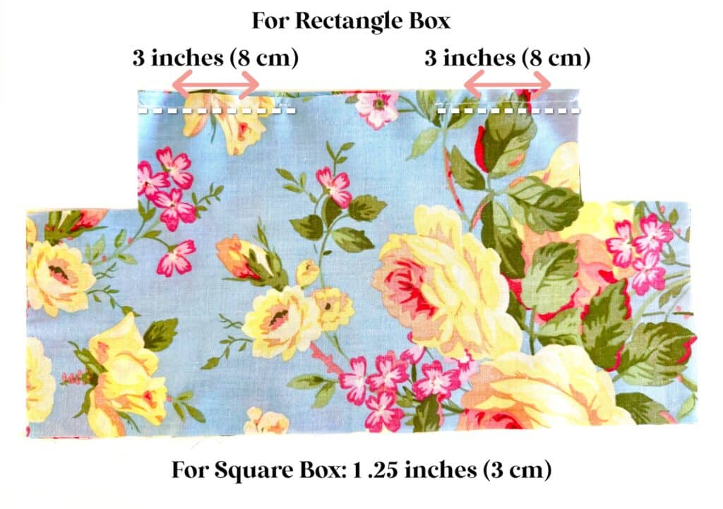Floral fabric piece with rectangular cutouts on each side, perfect for a tissue box cover; top edge marked with two arrows indicating 3-inch (8 cm) sections for rectangle box instructions.