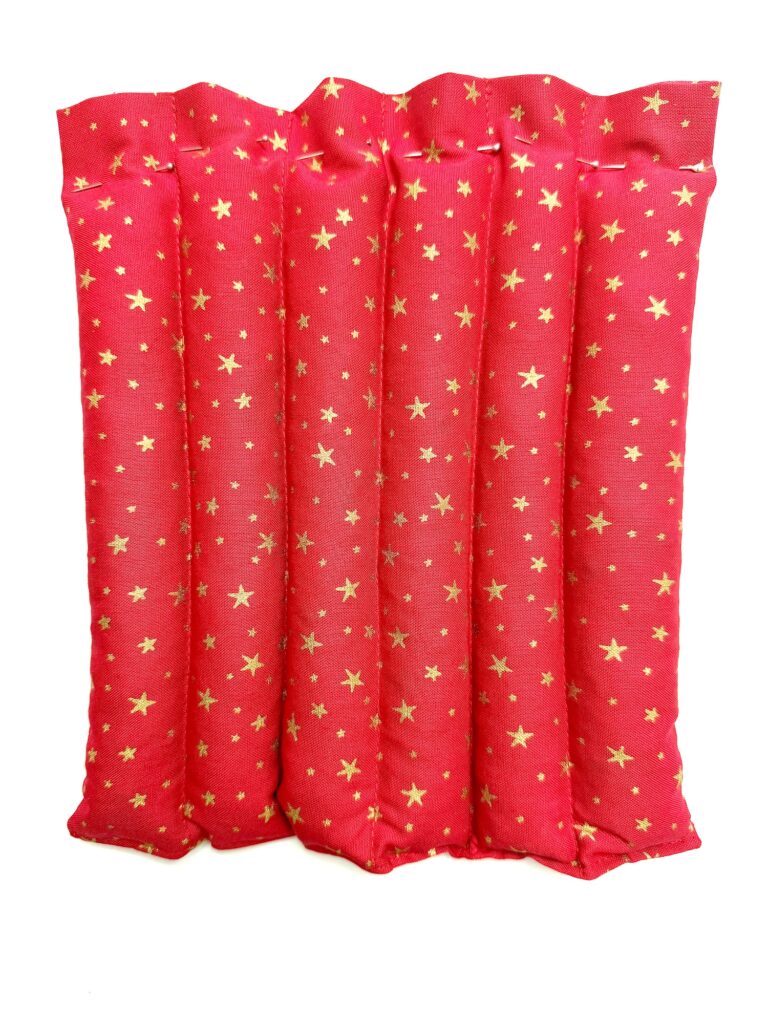 A red curtain with gold star patterns is shown against a white background.