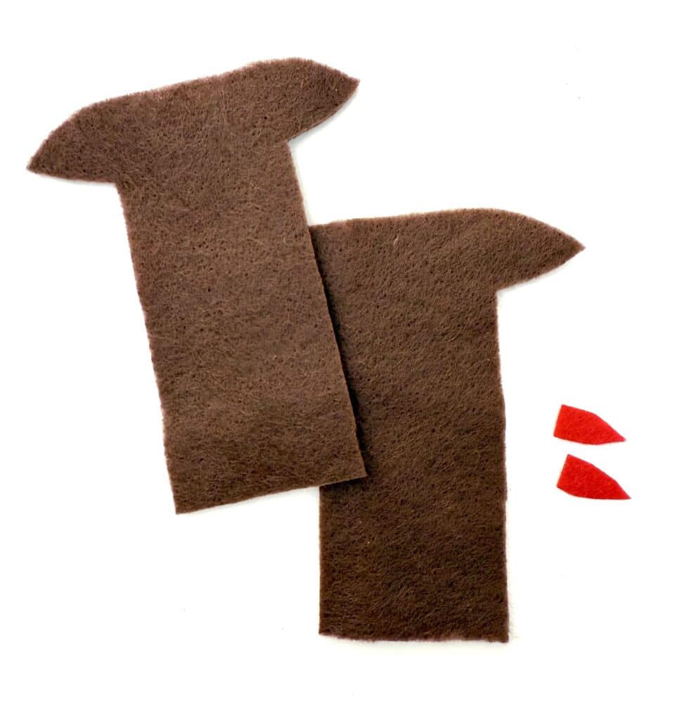 Two rectangular pieces of brown felt with one pointed end each, and two small red felt shapes, all placed on a white background.